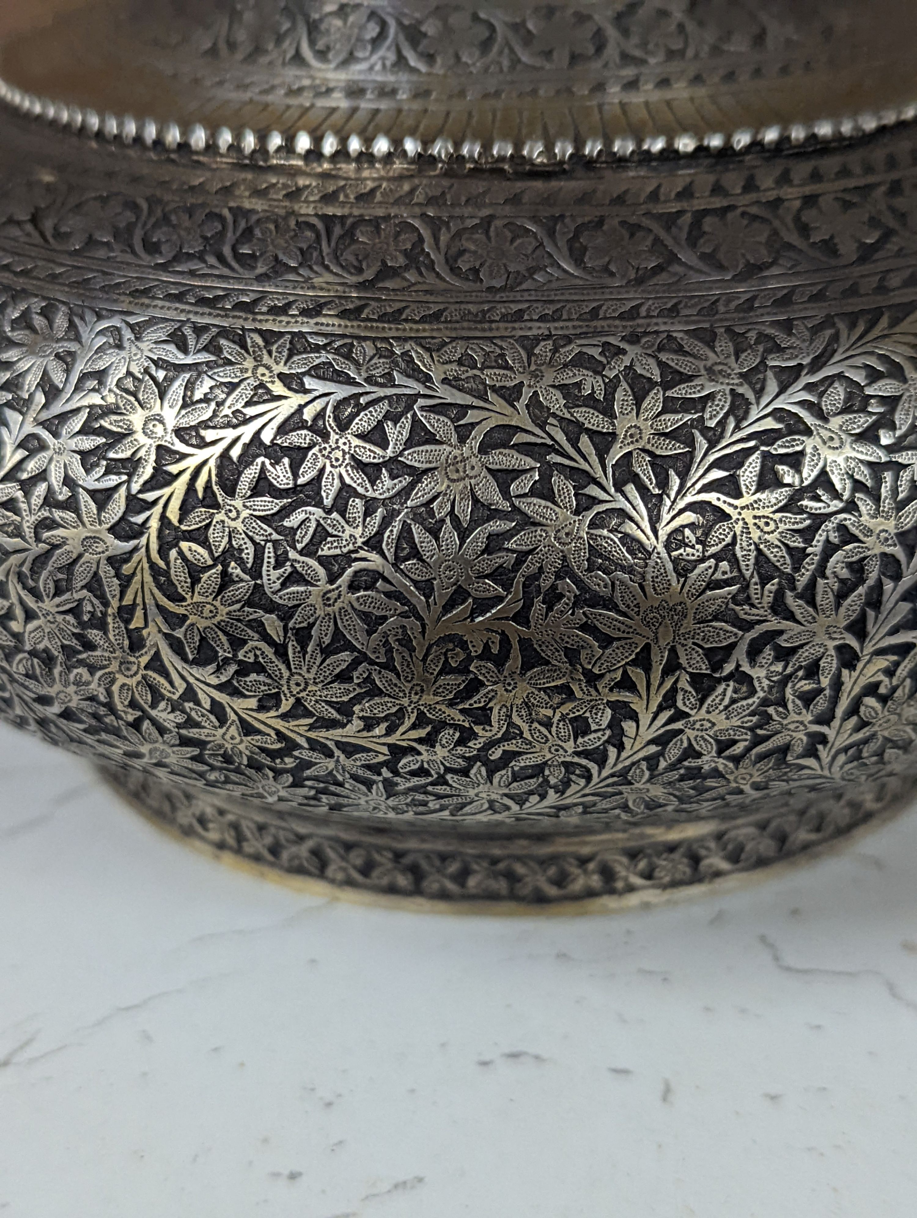 A 19th century North Indian silver surahi with engraved shawl decoration 30cm